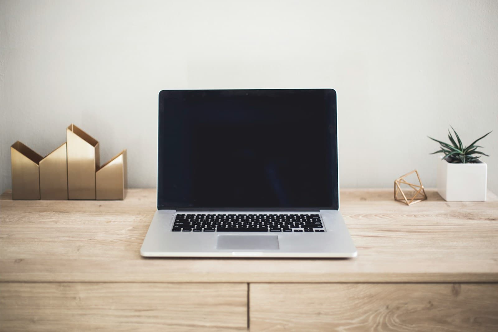 An open laptop on a clean wooden desk, ready for a website to be tested after the chat widget install