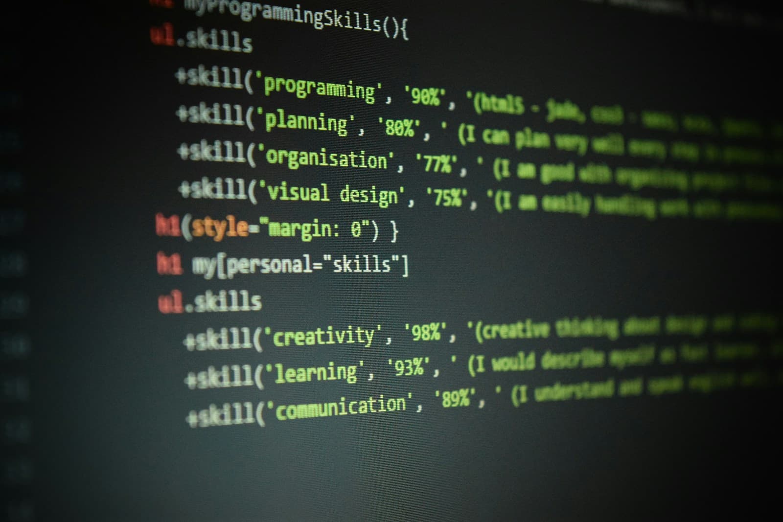 A laptop on a desk showing a web page's HTML source code in a text editor
